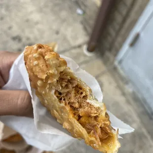 a hand holding a pastry