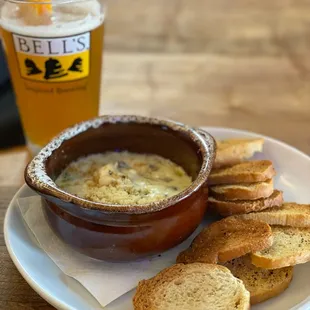 a bowl of soup and bread on a plate