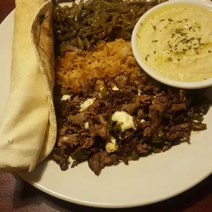 Pecan beef with rice, pita, hummus,  and loubier (top.)