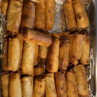 a tray of fried spring rolls