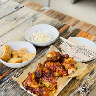 a plate of chicken wings and a bowl of coleslaw