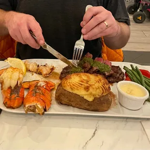 Carne asada with lobster tails and twice baked potato