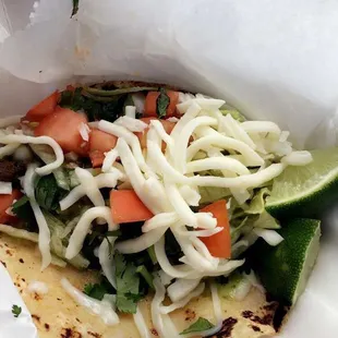 Steak street taco with cheese added upon request. Their homemade hot sauce is to die for too!