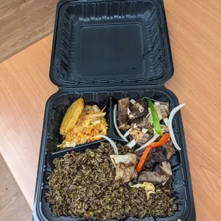 Haitian black rice, goat and pikliz with banan peze