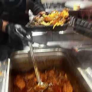 a person preparing food in a buffet