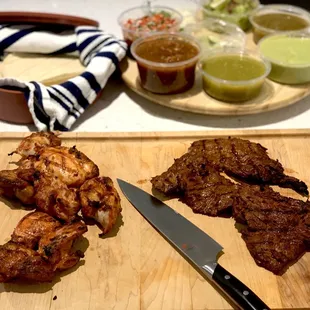 a cutting board with a variety of meats