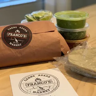 a sandwich wrapped in a brown paper bag