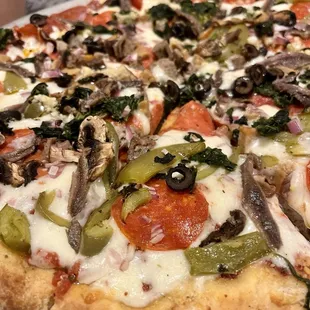 Supreme pizza with anchovies