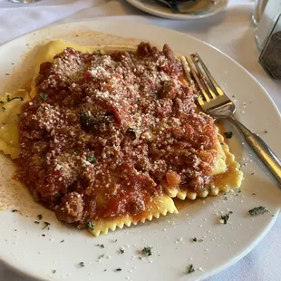Meat and cheese ravioli with meat sauce.