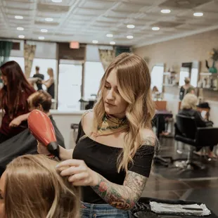 A blow dry is complimentary with a cut or color service.