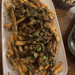 Beef Bites (over fries) with lemon and herb. Tasty and a big portion