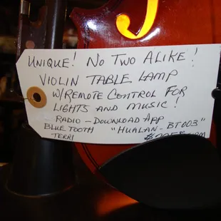 Price tag with a description of the violin art - sculpture - lamp - speaker.