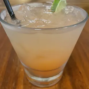 a cocktail with a lime wedge