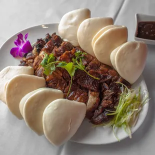Peking Duck: Boneless slices, roasted and served with steamed buns