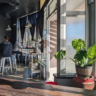 people sitting at tables in a restaurant