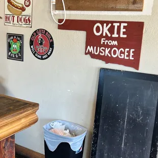 ows a kitchen with a table and a trash can