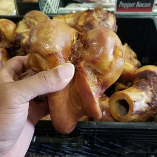 a hand holding a piece of meat