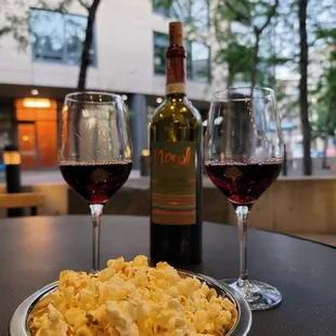 two glasses of wine and a plate of macaroni and cheese