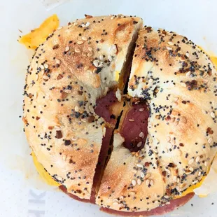a bagel with cheese and sausage