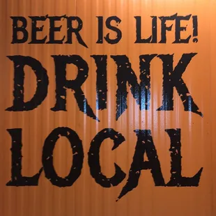 a sign that says beer is life drink local