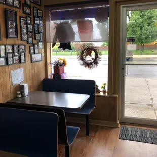 a table and chairs in front of a window