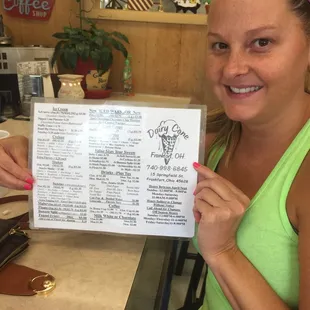 a woman holding a menu
