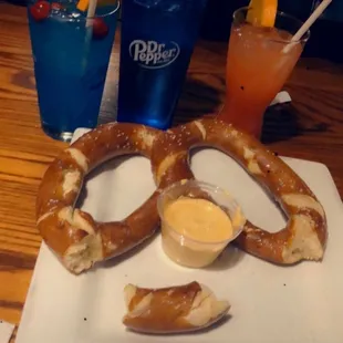 Warm pretzel with cheese sauce