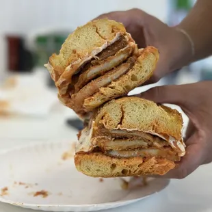 a person holding a sandwich