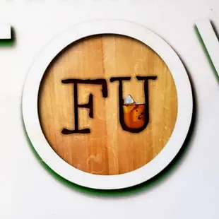a wooden sign with the letter u on it