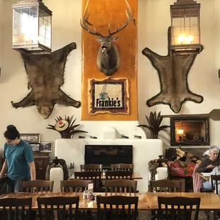 a dining room with deer heads on the wall
