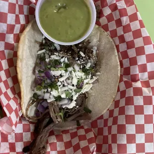 a taco with a side of guacamole