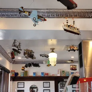 a bunch of toy cars hanging from the ceiling