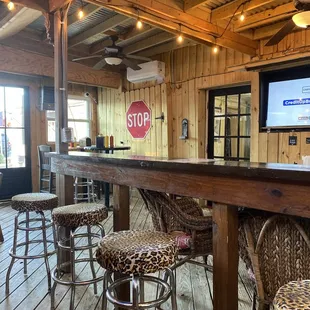 a bar with stools and a stop sign