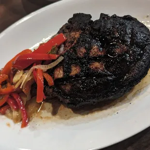 An over-charred and over-cooked pork chop.
