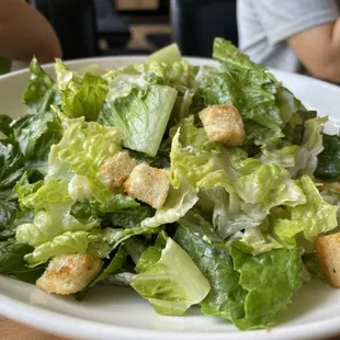 Caesar salad with crunchy croutons and slices of parm