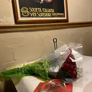 a bouquet of roses and a book on a table