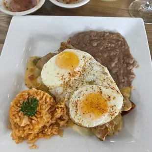 Steve&apos;s enchiladas with sunrise sauce with easy eggs.