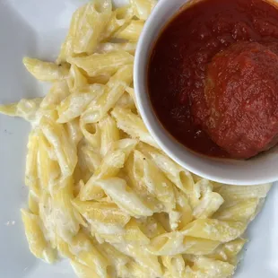 Gluten free pasta alfredo with a meatball in marina