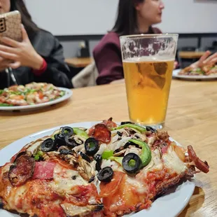 a plate of pizza and a glass of beer