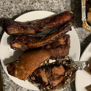 a plate of ribs and potatoes