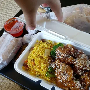 Sesame chicken lunch special with pork egg roll, shrimp egg roll, and crab rangoon