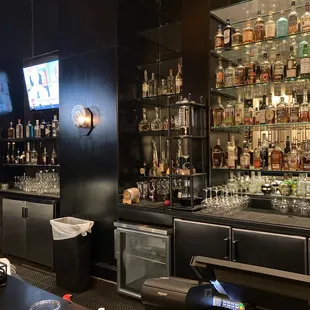 a bar with a lot of liquor bottles