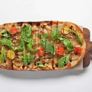 a pizza on a wooden cutting board