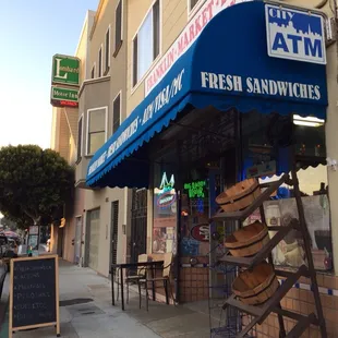 a storefront with a blue awning