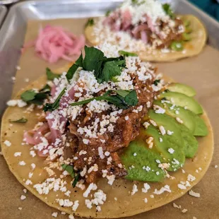 Pineapple Chipotle Tacos. $18. Braised pulled pork, pineapple sauce, chipotle, coriander, ginger, orange, avocado, pickled onion, cilantro+.