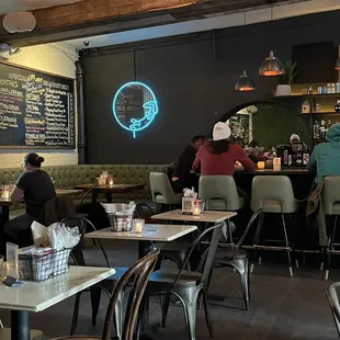people sitting at tables in a restaurant