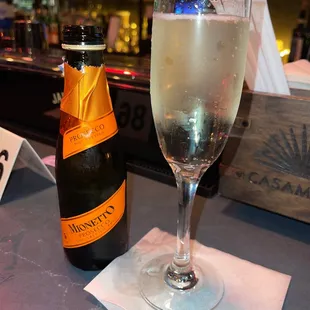 a glass of champagne and a bottle of champagne