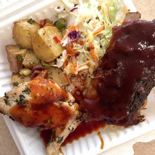 Outdoor BBQ: pork ribs, chicken, potatoes &amp; coleslaw.