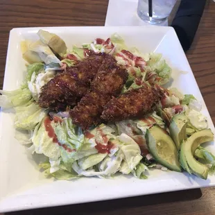 a plate of salad and a glass of water