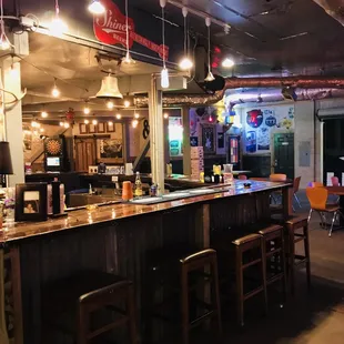 a bar with stools and tables